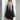Avant-garde black plaid tulle midi dress featuring long sleeves and a defined waist, worn by a model with black hair, showcasing a unique and edgy fashion statement.