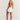 Backless white mini dress with a pleated skirt and pearl straps, ideal for party wear.