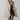 Beige fur-lined women's trench coat featuring luxurious fur collar and cuffs, with a tailored fit that accentuates the waist and extends to the knee, ideal for winter fashion.