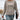 Woman wearing a beige ribbed knit pullover sweater, showcasing its cozy and lightweight fabric, perfect for fall fashion.