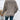 Woman wearing a beige ribbed knit pullover sweater, perfect for fall, with long sleeves and a lightweight design.