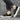 Beige striped men's fashion sneakers with a trendy lace-up design, paired with denim jeans.