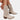 Beige suede knee-high cowboy boots for women, showcasing a stylish and breathable design, worn on a model's legs with emphasis on the knee and thigh area.