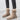 Beige suede women's winter boots with a knee-high design, featuring a zipper closure, fluffy lining, and a non-slip sole.
