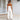 Beige tie-waist sleeveless jumpsuit featuring a fitted waist, sleeveless design, and elegant casual style suitable for summer wear.