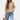 Beige women's bouclé double-breasted blazer with notched collar and long sleeves, styled as chic fall outerwear.