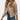 Beige women's bouclé double-breasted blazer with a tailored fit, featuring long sleeves and a classic collar, styled with jeans in a chic fall fashion setting.