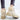 Beige women's fleece-lined winter ankle boots with plush chunky soles, shown worn with jeans.