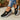 Purple slip-on mesh sneakers for women with a breathable design, showcased on a model's foot.