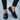 Black crocodile loafers for women, luxury designer slip-on shoes, paired with grey denim pants.