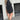 Black denim dress featuring long sleeves and a knee-length design, paired with a stylish fringe purse and complemented by Western ankle boots.