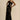 Black floral sheer one-shoulder evening dress displayed on a mannequin, highlighting its elegant design with a floral pattern, asymmetrical neckline, and sheer fabric.