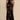 Black floral sheer one-shoulder evening dress displayed on a mannequin, highlighting the dress's elegant asymmetrical design with a sheer fabric that features a floral pattern, showing the shoulder, arm, and waist details.