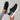 Black leopard print women's stylish comfortable sneakers worn by a person, featuring a grey synthetic rubber sole, suitable for walking and outdoor activities.