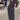 A woman wearing a black long sleeve maxi dress with pockets, showcasing an elegant and versatile style suitable for formal events. The dress features a fitted waist and floor-length design, ideal for making a fashion statement.