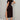 Black midi dress with side slit, casual street style, short sleeve, showing arm and leg details.