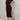 A woman wearing a black midi dress with a side slit, short sleeves, and casual street style.