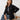 Woman wearing a black oversized denim jacket.