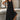 Black sleeveless midi dress with a flowy silhouette, featuring a button front design suitable for casual summer wear.