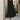A black sleeveless midi summer dress with a flowy design and button front, displayed against a white background. The dress is styled casually with a focus on its simple, elegant silhouette.