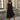 A black sleeveless midi summer dress with a flowy design and a button-front closure, ideal for casual outings.