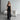 Black sleeveless evening gown with a high slit, showcasing a slim fit design; features a maxi length and elegant silhouette, ideal for formal occasions.