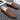 Black textured leather slip-on loafers for men with a zipper detail, showcasing a sleek and sophisticated design suitable for formal occasions.