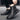 Black urban high-top sneakers for men, styled with durable materials, shown worn with denim and featuring fashionable elements in black, grey, and electric blue tones.