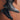 Black high-top sneakers featuring a sleek urban design, intended for men's streetwear. The sneakers showcase a durable and stylish appearance, primarily in black with accents of electric blue. Made with synthetic rubber, they combine the aesthetics of athletic shoes with the robustness of work boots.