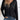 Black V-neck long sleeve blouse for women, paired with jeans, highlighting casual and lightweight design.