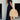 Black V-neck open back maxi dress showcasing a stylish, flowing design with a focus on summer streetwear fashion. The dress features a sleeveless cut, accentuating the shoulders and waist, and extends to the knees, embodying a chic and elegant look perfect for warm weather.