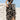 Off-shoulder two-piece dress with abstract black and white pattern, featuring a flowing palazzo pant and complementing top, worn by a model with black hair, highlighting fashion design elements.