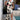 Black and white floral asymmetrical dress featuring an elegant design, perfect for summer evenings. The dress highlights a one-piece garment style, emphasizing the shoulder and neck area, with a fashionable and flattering waistline.