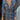 Woman wearing a blue floral midi dress with a V-neck and long sleeves, suitable for fall fashion and evening events.
