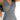 A woman modeling a blue and white geometric patterned V-neck sleeveless A-line summer dress.