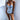 Blue and white porcelain one-piece swimsuit featuring a tropical palm design, shown on a model.