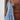 Woman wearing a blue and white v-neck boho maxi dress with a lightweight, flowy design, suitable for summer beachwear.