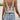 White bohemian floral lace tank top featuring a tassel tie back, displayed on a mannequin, highlighting its sleeveless design and intricate lace details suitable for women's summer fashion.