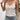 Bohemian floral lace tank top for women featuring a sleeveless design, white fabric, and a tassel tie back, styled for a fashionable summer look.