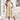 Bohemian Floral Midi Dress with Puffed Sleeves featuring a vibrant floral pattern, cinched waist, and flowing skirt, styled with a wide-brimmed hat and sunglasses for a chic summer look.