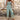 Bohemian floral wide-leg jumpsuit for women designed as a stylish summer beach outfit. The jumpsuit features a fashion-forward one-piece design with a flattering grey floral pattern, sleeveless cut, and wide-leg pants. Perfect for standing out at any summer event.