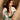 Bohemian green embroidered V-neck maxi dress with puff sleeves and a belted waist, worn by a smiling woman.