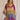 A woman wearing a luxurious Bohemian V-Neck Tribal Print Kaftan Dress in purple with short sleeves and a flowing waistline, perfect for summer beachwear.