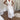 Bohemian V-neck white lace summer dress featuring elegant and casual style with delicate lace detailing, showcasing short sleeves and a flattering waistline.