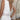Bohemian V-neck white lace summer dress featuring casual and elegant style, showcasing intricate lace details on the sleeves and waist, with a flattering silhouette. The dress is worn by a model standing with visible shoulder and arm features, emphasizing the garment's light and airy design.