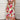 Boho Chic Floral Maxi Dress with cutout waist, featuring a woman smiling and posing with visible shoulder and arm, showcasing the floral pattern and elegant flow of the white, one-piece beachwear garment.