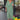 Bright floral V-neck kaftan dress with short sleeves and a flowy waist, designed as a summer beach coverup. The dress features vibrant green and various colorful floral patterns.