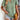Woman wearing a brown pleated V-neck casual summer top made of soft fabric, showcasing the top's design and fit with visible shoulders and arms.