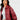 Burgundy oversized leather bomber jacket worn by a woman, showcasing trendy fall outerwear with a stylish collar and sleeves.