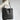 Caramel oversized full-grain leather tote bag with a minimalist and durable design, featuring a spacious main compartment and sturdy shoulder straps.